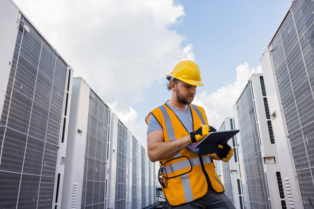 Commercial Condenser coil cleaning technician measuring performance