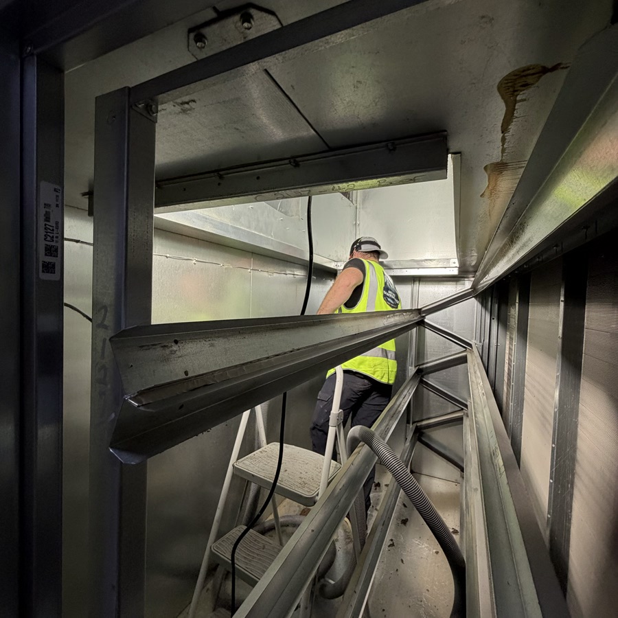 a man cleaning the inside of an air handler