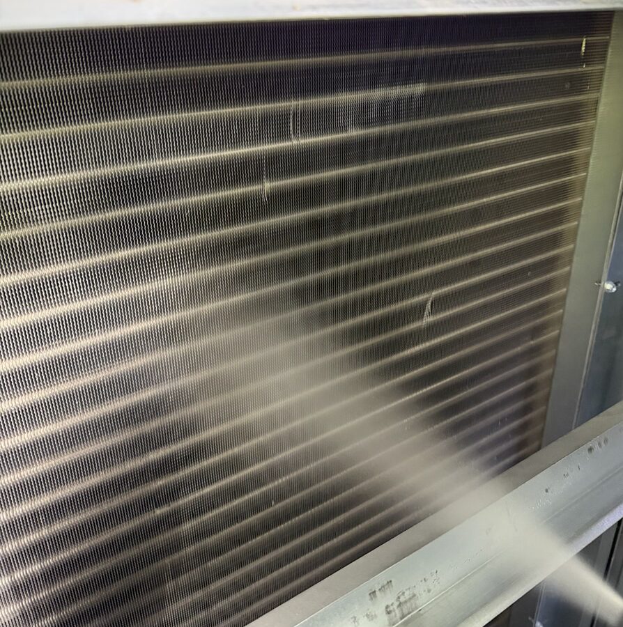 sprayer cleaing an indoor commercial HVAC coil